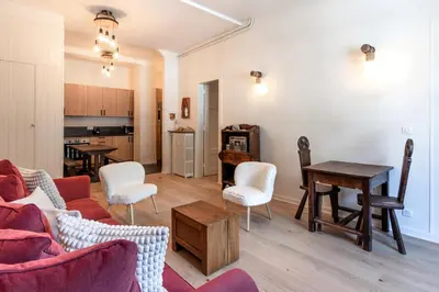 a living room with a couch and chairs and a table at Majestic - Appartement 2 pas du centre-ville Chamo in Chamonix-Mont-Blanc