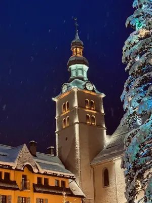 a building with a clock tower on top of it at Chalet LE REPAIRE proches des Pistes in Megève