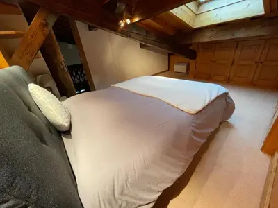 a bedroom with a large bed in a room at Chalet LE REPAIRE proches des Pistes in Megève