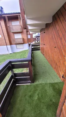 an external view of a building with green grass at Très bel appartement spacieux in Les Carroz d'Araches