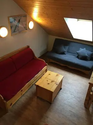 a living room with a couch and a table at Next to the ski lift! *3bed Apt* sleeps 8* Parking* Pool in Saint-Gervais-les-Bains