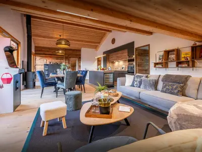 a living room with a couch and a table at Le Primpiolet - OVO Network in Combloux