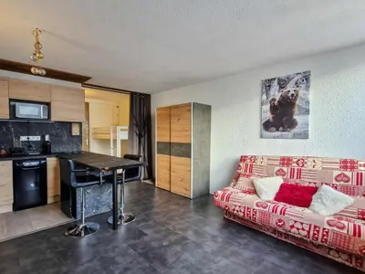 a living room with a couch and a table at Studio rénové à Flaine · Balcon Sud · Idéal pour 4 personnes - FR-1-425-209 in Arâches-la-Frasse