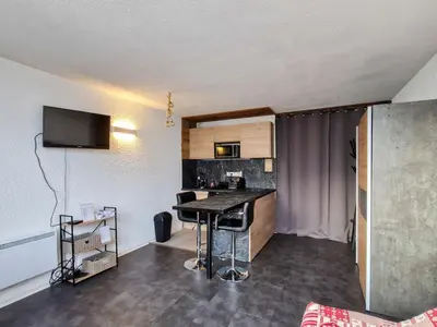 a small kitchen with a table in a room at Studio rénové à Flaine · Balcon Sud · Idéal pour 4 personnes - FR-1-425-209 in Arâches-la-Frasse