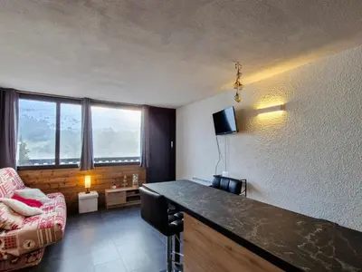 a room with a living room with a couch and a table at Studio rénové à Flaine · Balcon Sud · Idéal pour 4 personnes - FR-1-425-209 in Arâches-la-Frasse