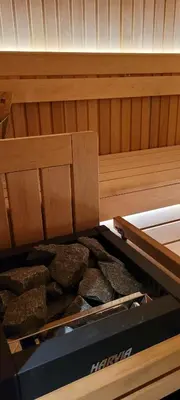 a bed in a sauna with a pile of rocks at Les petites chambres St Gervais in Saint-Gervais-les-Bains