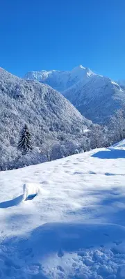 a snow covered field with a mountain in the background at Les petites chambres St Gervais in Saint-Gervais-les-Bains