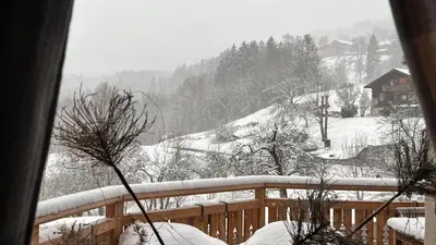 a view of a snow covered mountain from a balcony at Hygge and Lykke in Saint-Gervais-les-Bains