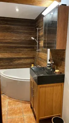 a bathroom with a bath tub and a sink at Hygge and Lykke in Saint-Gervais-les-Bains
