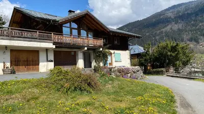 a house with a balcony on the side of a road at Hygge and Lykke in Saint-Gervais-les-Bains