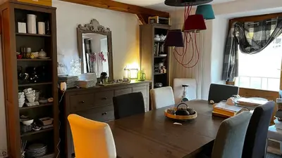a dining room with a wooden table and chairs at Hygge and Lykke in Saint-Gervais-les-Bains
