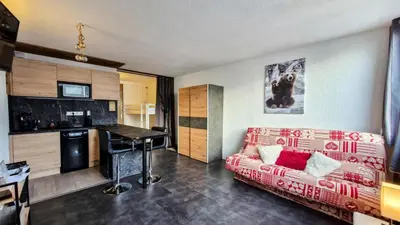 a living room with a couch and a table at Résidence Gemeaux - Studio rénové · Centre station · Balcon MAE-0491 in Magland