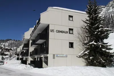 a building with the words us germany on it in the snow at Résidence Gemeaux - Studio rénové · Centre station · Balcon MAE-0491 in Magland