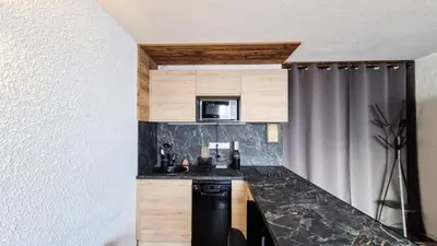 a kitchen with a sink and a microwave at Résidence Gemeaux - Studio rénové · Centre station · Balcon MAE-0491 in Magland
