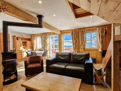 a living room with a couch and a stove at Chalet lumineux à Flaine avec garage et grand salon - FR-1-425-210 in Arâches-la-Frasse
