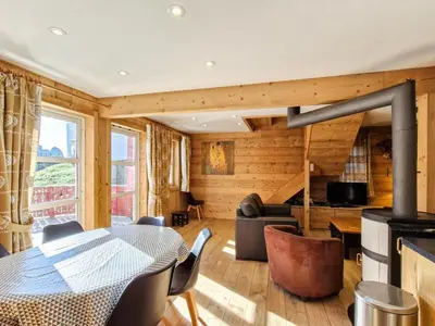 a living room with a table and a fireplace at Chalet lumineux à Flaine avec garage et grand salon - FR-1-425-210 in Arâches-la-Frasse