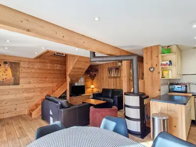 a living room with wooden walls and a staircase at Chalet lumineux à Flaine avec garage et grand salon - FR-1-425-210 in Arâches-la-Frasse