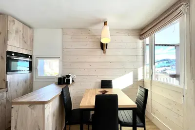 a dining room with a wooden table and chairs at Le Balcon des Princesses in Demi-Quartier