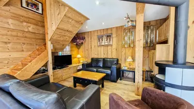 a living room with wood paneling and a fireplace at Résidence Hameau - Chalet lumineux · Poêle à bois · WIFI gratuit et illimité · Garage MAE-1691 in Magland