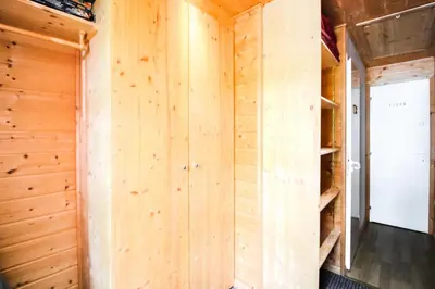 a wooden wall in a cabin with a closet at Résidence Hameau - Chalet lumineux · Poêle à bois · WIFI gratuit et illimité · Garage MAE-1691 in Magland