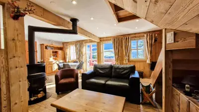 a living room with a couch and a stove at Résidence Hameau - Chalet lumineux · Poêle à bois · WIFI gratuit et illimité · Garage MAE-1691 in Magland