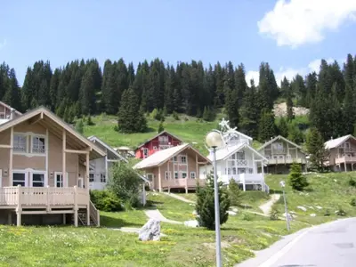 a row of houses on a hill with a street light at Résidence Hameau - Chalet lumineux · Poêle à bois · WIFI gratuit et illimité · Garage MAE-1691 in Magland
