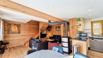 a kitchen and living room with wooden walls and ceilings at Résidence Hameau - Chalet lumineux · Poêle à bois · WIFI gratuit et illimité · Garage MAE-1691 in Magland