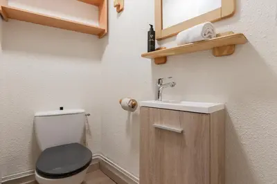 a small bathroom with a toilet and a sink at Les Chamois - Duplex - Vue magnifique in Chamonix-Mont-Blanc