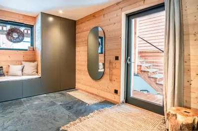 a room with wooden walls and a door with a window at Chalet Sia - Contemporain - Sauna prive in Chamonix-Mont-Blanc
