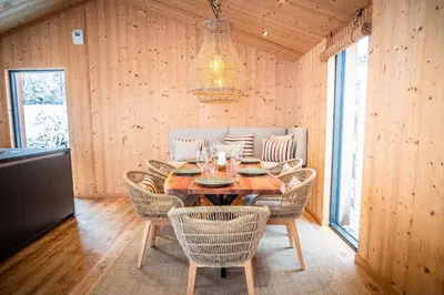 a wooden dining room with a table and chairs at Chalet Sia - Contemporain - Sauna prive in Chamonix-Mont-Blanc