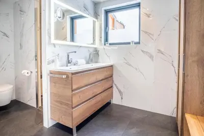a bathroom with a sink and a mirror at Chalet Sia - Contemporain - Sauna prive in Chamonix-Mont-Blanc
