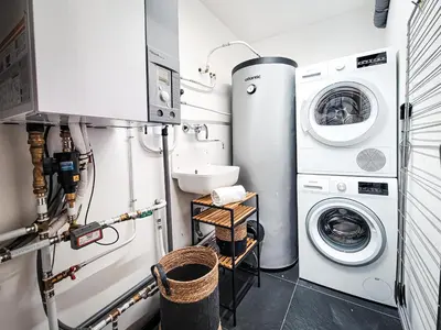 a laundry room with a washer and dryer at Chalet Sia - Contemporain - Sauna prive in Chamonix-Mont-Blanc