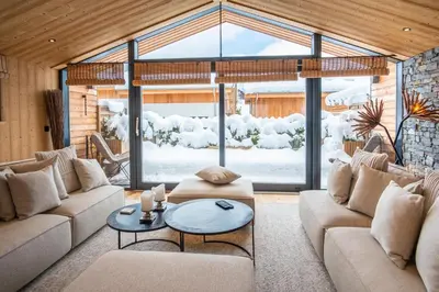 a living room with couches and a table at Chalet Sia - Contemporain - Sauna prive in Chamonix-Mont-Blanc