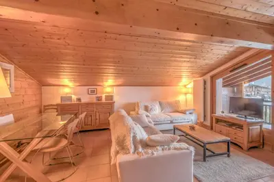 a living room with a couch and a table at Appartement Denali - Welkeys in Demi-Quartier