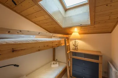 a bedroom with two bunk beds and a skylight at Appartement Denali - Welkeys in Demi-Quartier
