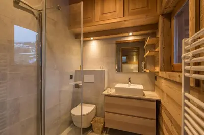 a bathroom with a toilet and a sink and a shower at Appartement Denali - Welkeys in Demi-Quartier
