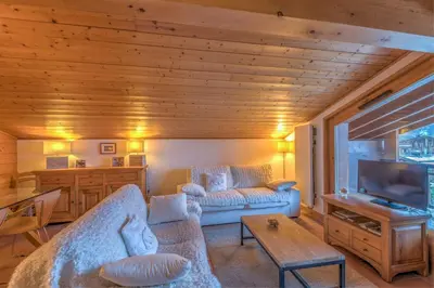 a living room with a couch and a tv at Appartement Denali - Welkeys in Demi-Quartier