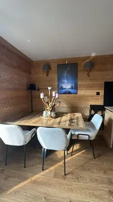 a dining room with a table and chairs at Très bel appartement avec parking gratuit in Megève