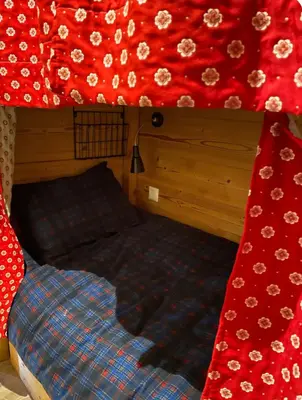 a bedroom with a bed with a red canopy at Très bel appartement avec parking gratuit in Megève