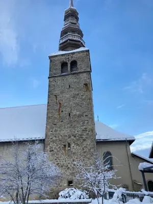 an old brick building with a tower on top at Renovated flat facing Mont Blanc in Combloux
