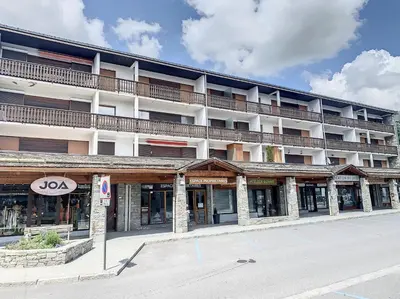 a large hotel building with a parking lot in front of it at 3 Pièces 6/8 Pers centre Carroz (AA111) in Les Carroz d'Araches