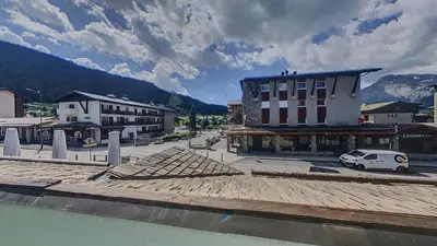 a town with a building and a street with cars at 3 Pièces 6/8 Pers centre Carroz (AA111) in Les Carroz d'Araches