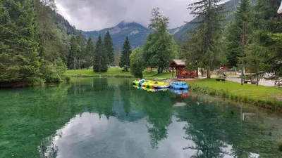a river with some boats in the middle of it at Studio au pied des remontées/wifi/smart TV/parking in Les Contamines-Montjoie