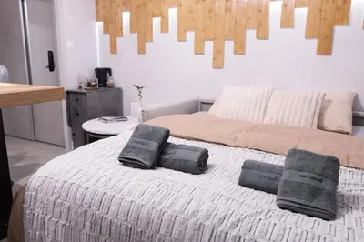 a bedroom with a bed with two pillows on it at Studio cabine Au Loup Blanc avec vue Mont Blanc in Saint-Gervais-les-Bains