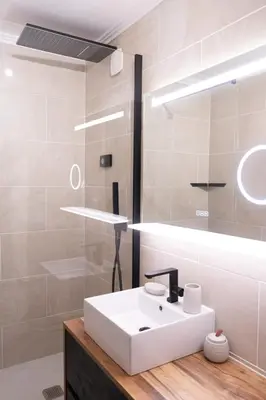 a bathroom with a white sink and a mirror at Studio cabine Au Loup Blanc avec vue Mont Blanc in Saint-Gervais-les-Bains