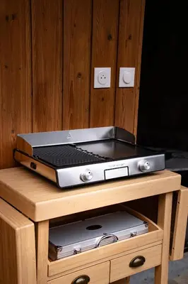 a toaster oven sitting on top of a wooden table at Studio cabine Au Loup Blanc avec vue Mont Blanc in Saint-Gervais-les-Bains