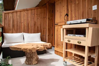 a room with a bed and a table and a bench at Studio cabine Au Loup Blanc avec vue Mont Blanc in Saint-Gervais-les-Bains