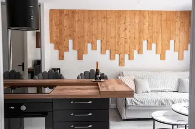 a living room with a table and a couch at Studio cabine Au Loup Blanc avec vue Mont Blanc in Saint-Gervais-les-Bains