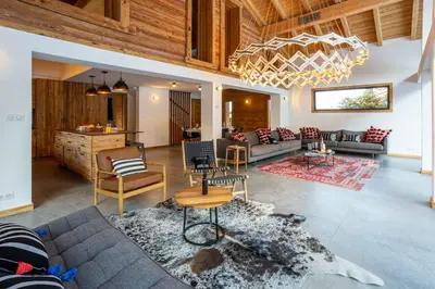 a living room with a couch and a table at Chalet Gloribel in Chamonix-Mont-Blanc