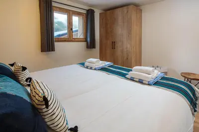 a bedroom with a large bed with towels on it at Chalet Gloribel in Chamonix-Mont-Blanc